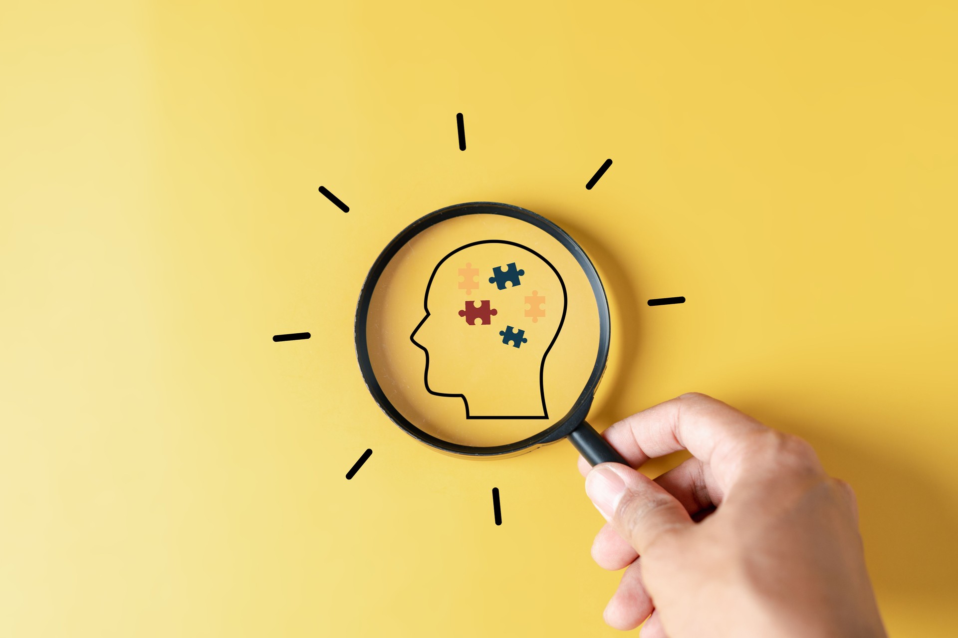 Magnifier focus to Human Brain white jigsaw puzzle, mental health, creative thinking, idea , brainstorm and autism awareness concept.